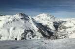 Experience the breathtaking beauty of the snow-capped mountains in this stunning winter landscape.