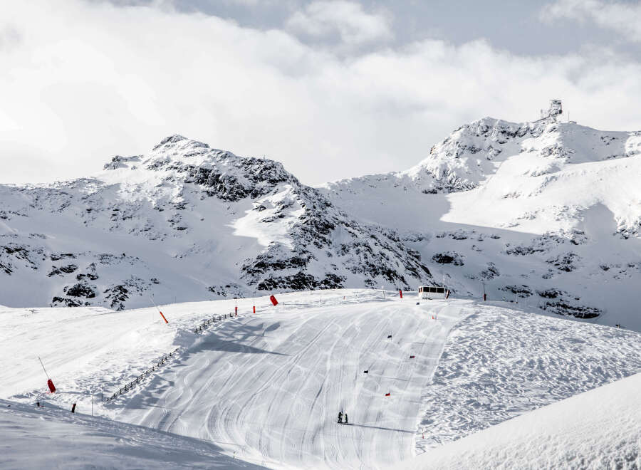 Experience the thrill of skiing down pristine slopes surrounded by majestic snow-capped mountains.