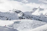 Experience the thrill of skiing down pristine slopes surrounded by majestic snow-capped mountains.