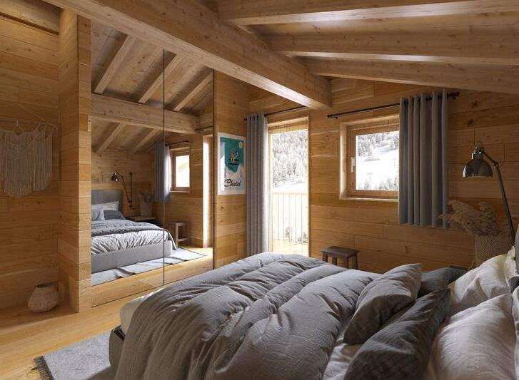Experience the warmth of this cozy bedroom, featuring stunning wooden paneling and exposed beams.