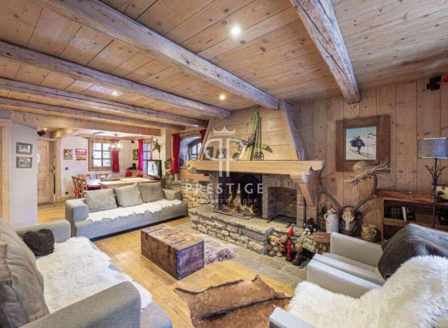 Experience the warmth of this stunning chalet, featuring a cozy fireplace and rustic wooden accents throughout.
