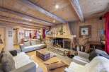 Experience the warmth of this stunning chalet, featuring a cozy fireplace and rustic wooden accents throughout.