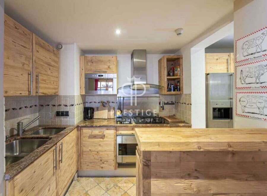 Discover a charming kitchen with rustic wooden cabinetry and a stylish island.