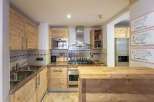 Discover a charming kitchen with rustic wooden cabinetry and a stylish island.