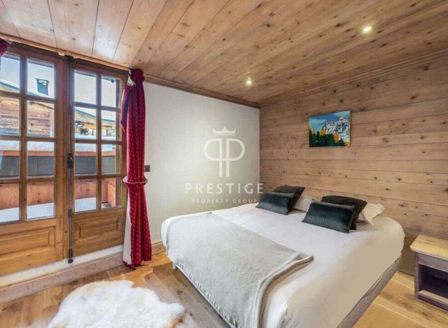 Experience the charm of this cozy bedroom, featuring a warm wooden ceiling and walls.