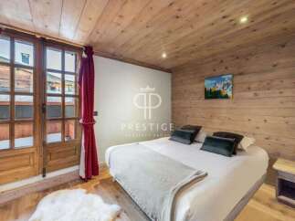 Experience the charm of this cozy bedroom, featuring a warm wooden ceiling and walls.
