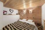 Cozy bedroom with wooden paneling and a warm, inviting atmosphere.