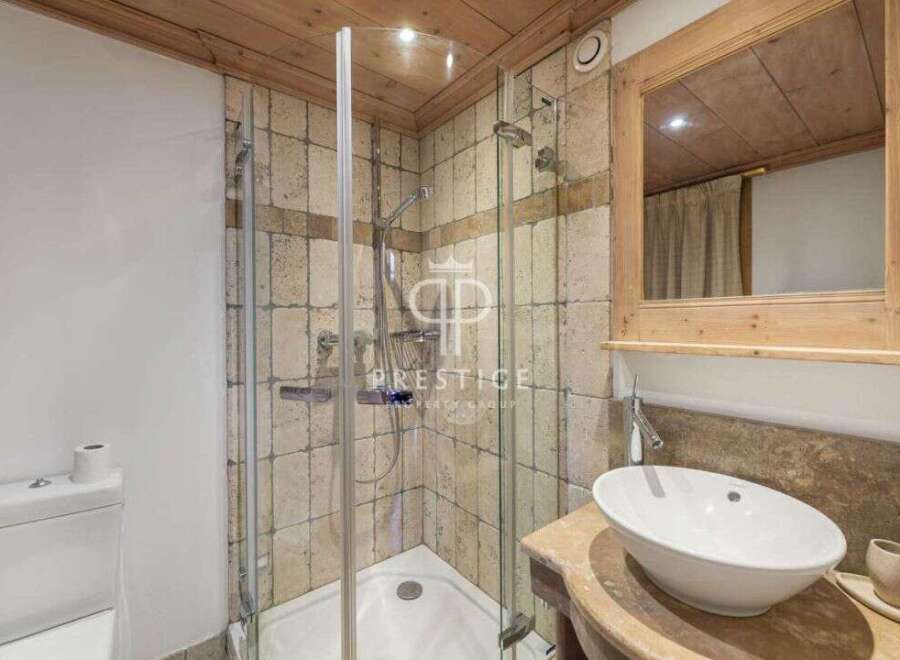 Discover a luxurious bathroom featuring a modern shower and elegant sink.