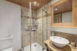 Discover a luxurious bathroom featuring a modern shower and elegant sink.