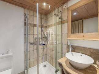 Discover a luxurious bathroom featuring a modern shower and elegant sink.
