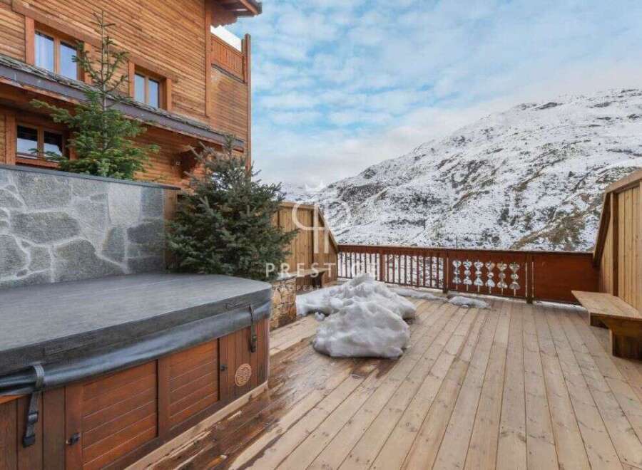 Experience luxury living in this stunning property with a private hot tub, perfect for relaxing after a day on the slopes.