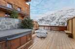 Experience luxury living in this stunning property with a private hot tub, perfect for relaxing after a day on the slopes.