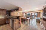 Discover the charm of this cozy property, featuring a warm wooden interior and a spacious open-plan living area.