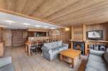 Discover the charm of this cozy living space, featuring a warm wooden interior and a welcoming fireplace.