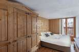 Discover the charm of this cozy bedroom, featuring rustic wooden accents and a warm, inviting atmosphere.