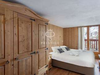 Discover the charm of this cozy bedroom, featuring rustic wooden accents and a warm, inviting atmosphere.