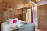 Discover the charm of this cozy bedroom, featuring rustic wooden accents and a warm, inviting atmosphere.