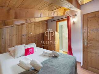 Discover the charm of this cozy bedroom, featuring rustic wooden accents and a warm, inviting atmosphere.