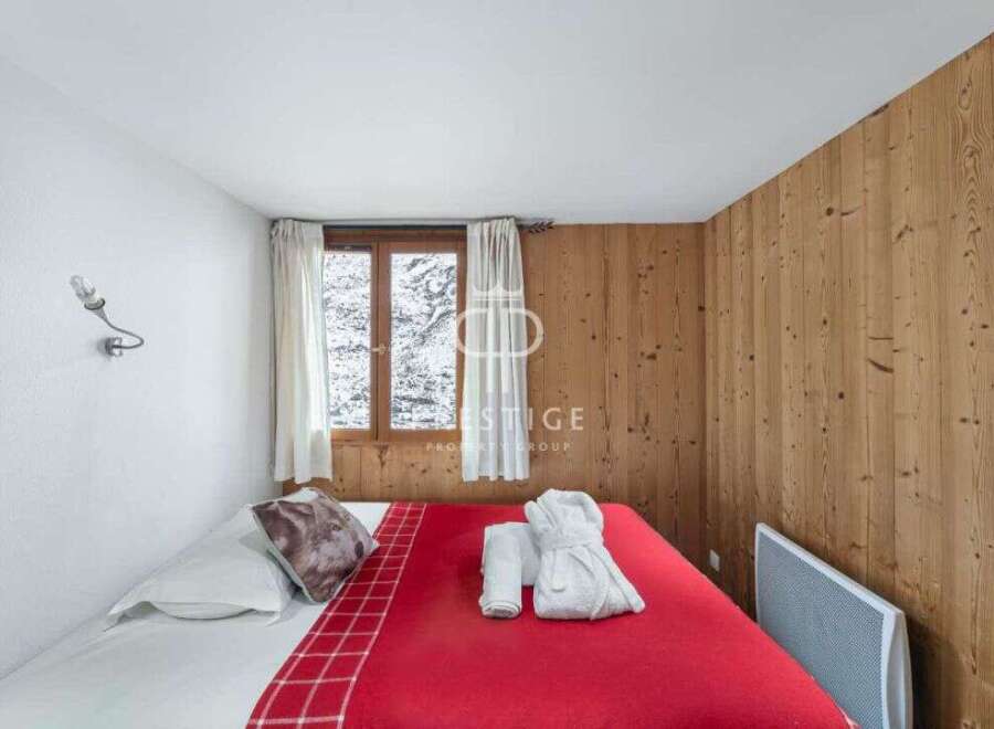 Cozy bedroom with a rustic wooden accent wall.