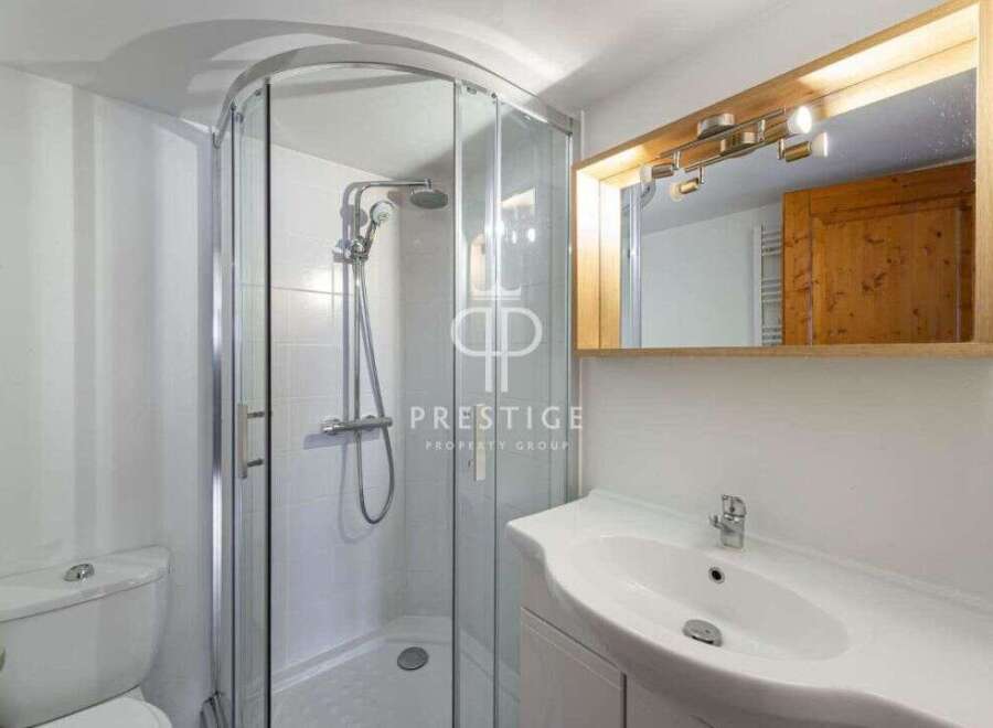 Discover a modern bathroom with a sleek shower enclosure and a stylish vanity.