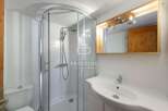 Discover a modern bathroom with a sleek shower enclosure and a stylish vanity.