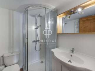 Discover a modern bathroom with a sleek shower enclosure and a stylish vanity.