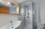 Discover a modern bathroom with a sleek shower enclosure and a stylish vanity.