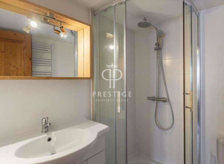 Discover a modern bathroom with a sleek shower and a stylish sink.