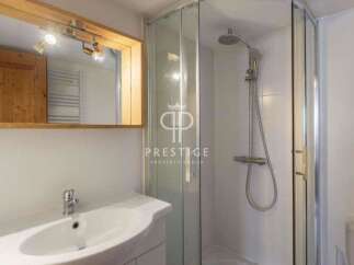 Discover a modern bathroom with a sleek shower and a stylish sink.