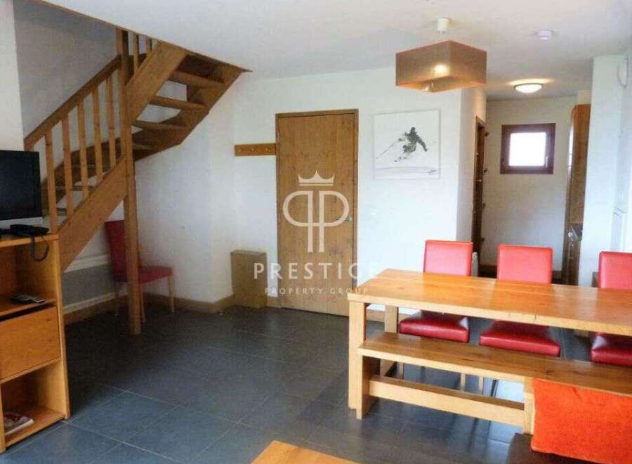 Discover this charming property featuring a cozy wooden staircase and a spacious dining area.