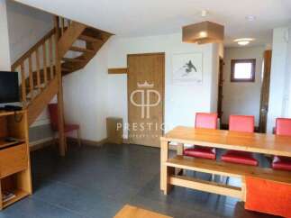 Discover this charming property featuring a cozy wooden staircase and a spacious dining area.