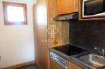 Discover a cozy kitchen with wooden cabinets and a sleek countertop.