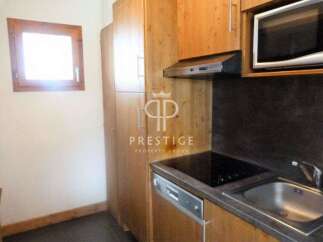Discover a cozy kitchen with wooden cabinets and a sleek countertop.