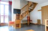 Discover this charming property featuring a cozy living space with a staircase leading to the upper level.