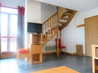 Discover this charming property featuring a cozy living space with a staircase leading to the upper level.