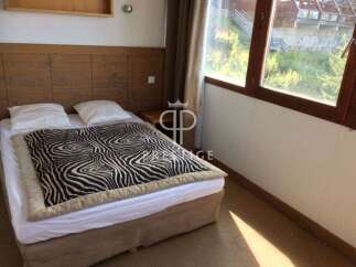 Cozy bedroom with a unique zebra-print blanket.