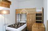 Discover a cozy bedroom featuring a unique bunk bed design, perfect for maximizing space.
