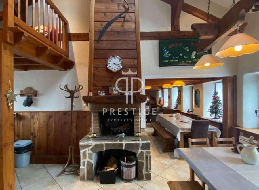 Discover the charm of this property, featuring a cozy fireplace and rustic wooden accents.