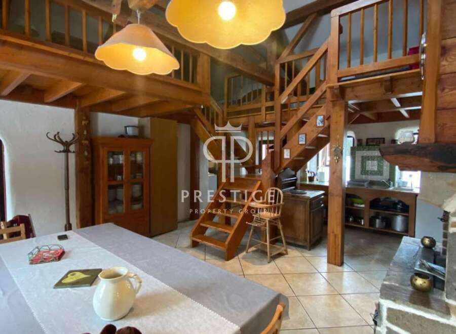 Discover the charm of this rustic property, featuring stunning wooden beams and a unique staircase design.