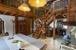 Discover the charm of this rustic property, featuring stunning wooden beams and a unique staircase design.