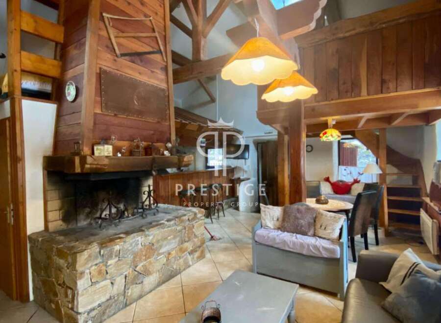 Discover the charm of this stunning property, featuring a cozy fireplace and exposed wooden beams that exude warmth and character.