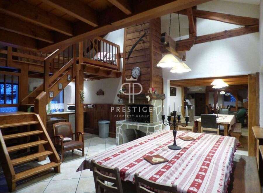 Discover rustic charm in this stunning property, featuring exposed wooden beams and a cozy fireplace.