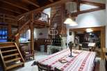 Discover rustic charm in this stunning property, featuring exposed wooden beams and a cozy fireplace.