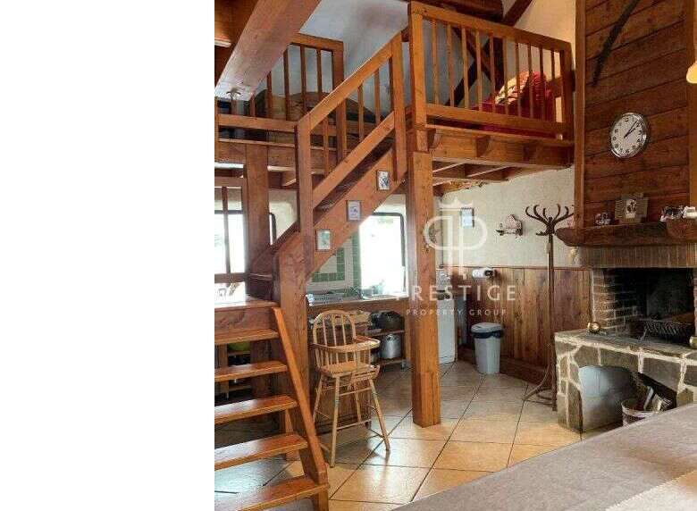 Discover the charm of this unique property featuring a stunning wooden staircase and a cozy loft area.