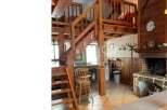 Discover the charm of this unique property featuring a stunning wooden staircase and a cozy loft area.