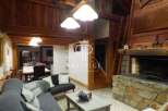 Discover the charm of this stunning property, featuring a cozy living room with a fireplace and exposed wooden beams.