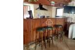 Discover the charm of this property, featuring a rustic wooden bar perfect for entertaining.