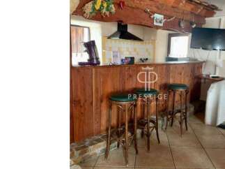 Discover the charm of this property, featuring a rustic wooden bar perfect for entertaining.