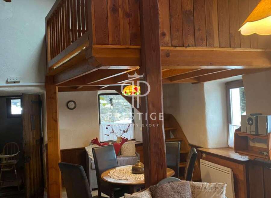 Discover the charm of this unique property, featuring a cozy interior with wooden accents and a loft area.