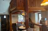 Discover the charm of this unique property, featuring a cozy interior with wooden accents and a loft area.